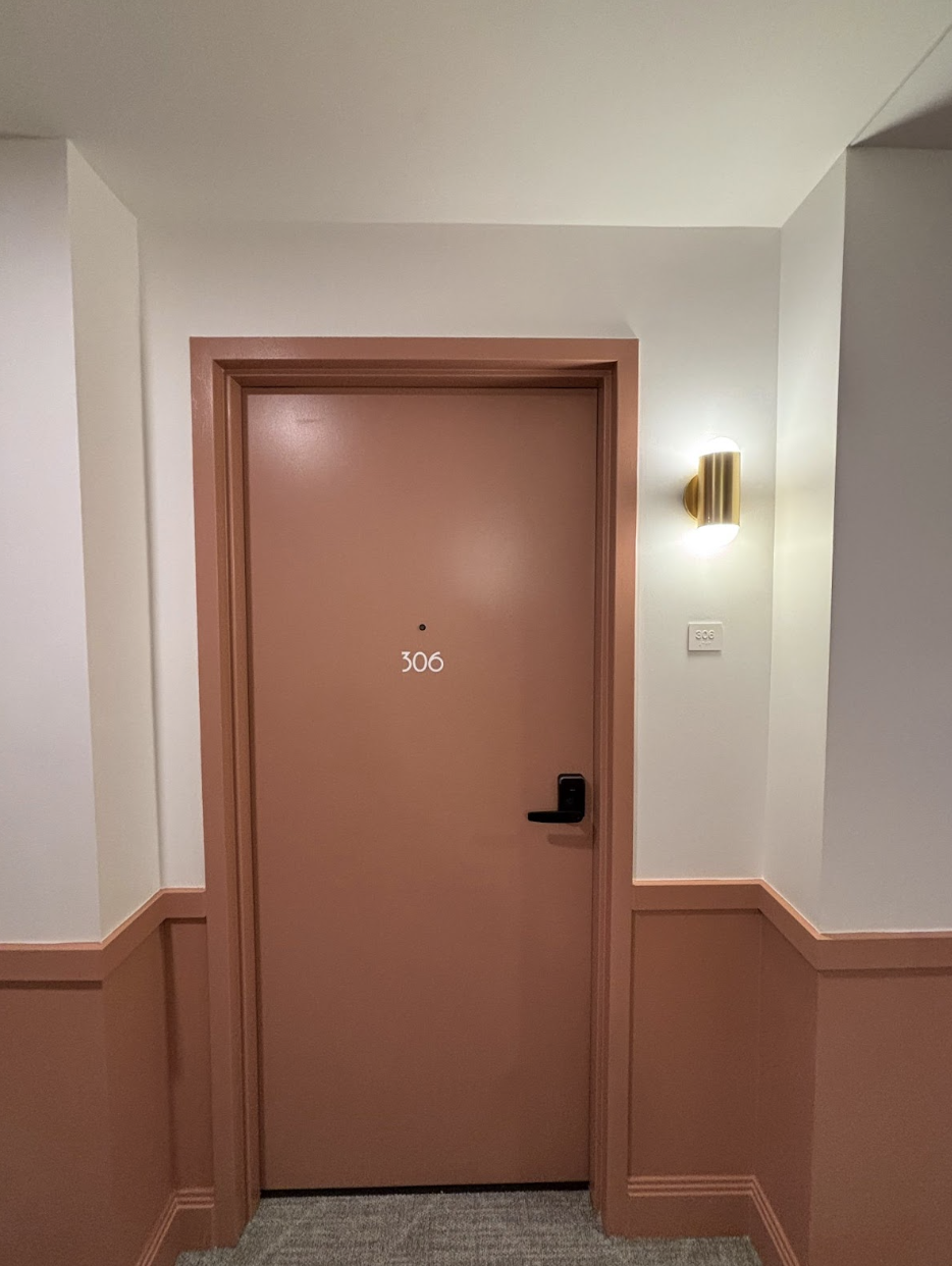 Hallway and door of a unit at Rambler Atlanta. 